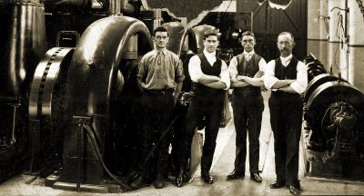 NMETL power station crew next to generator set. Photograph TMSV archive.